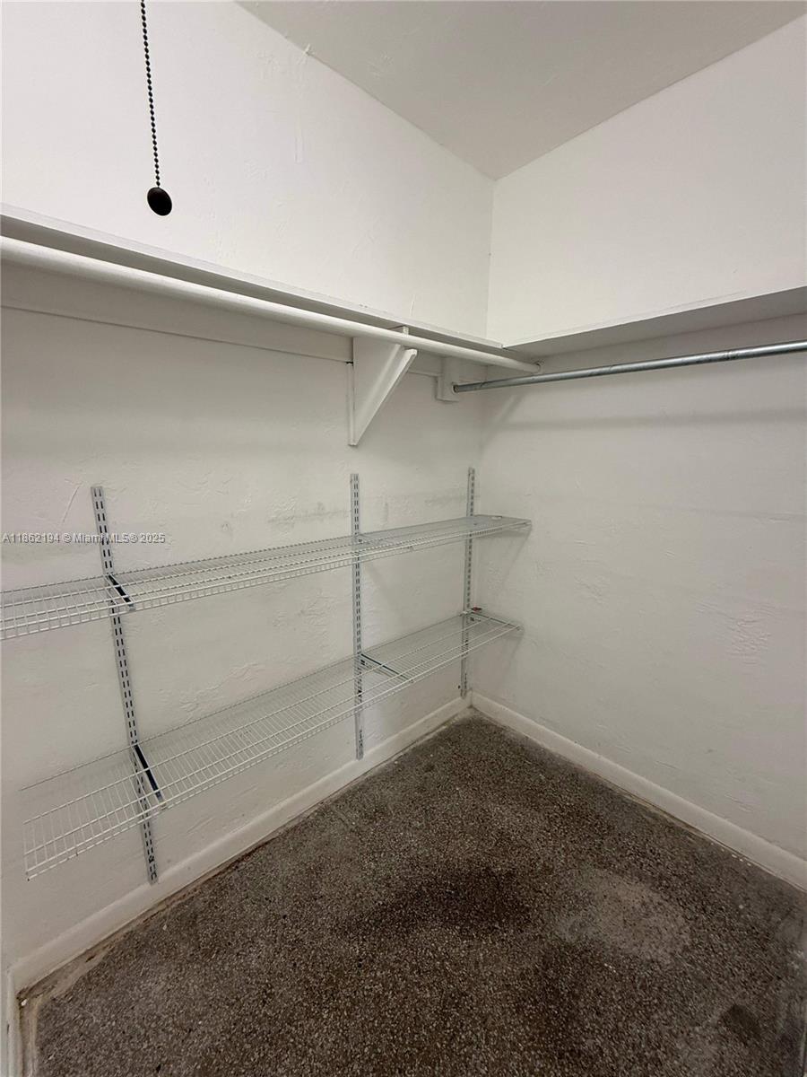 361 Sharar Avenue, Unit 1 Opa-Locka, FL 33054 - Photo 6 of 11 a view of a room with racks on the wall