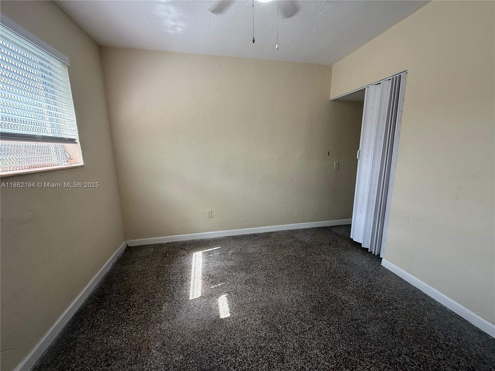 361 Sharar Avenue, Unit 1 Opa-Locka, FL 33054 - Photo 7 of 11 an empty room with a empty space and window