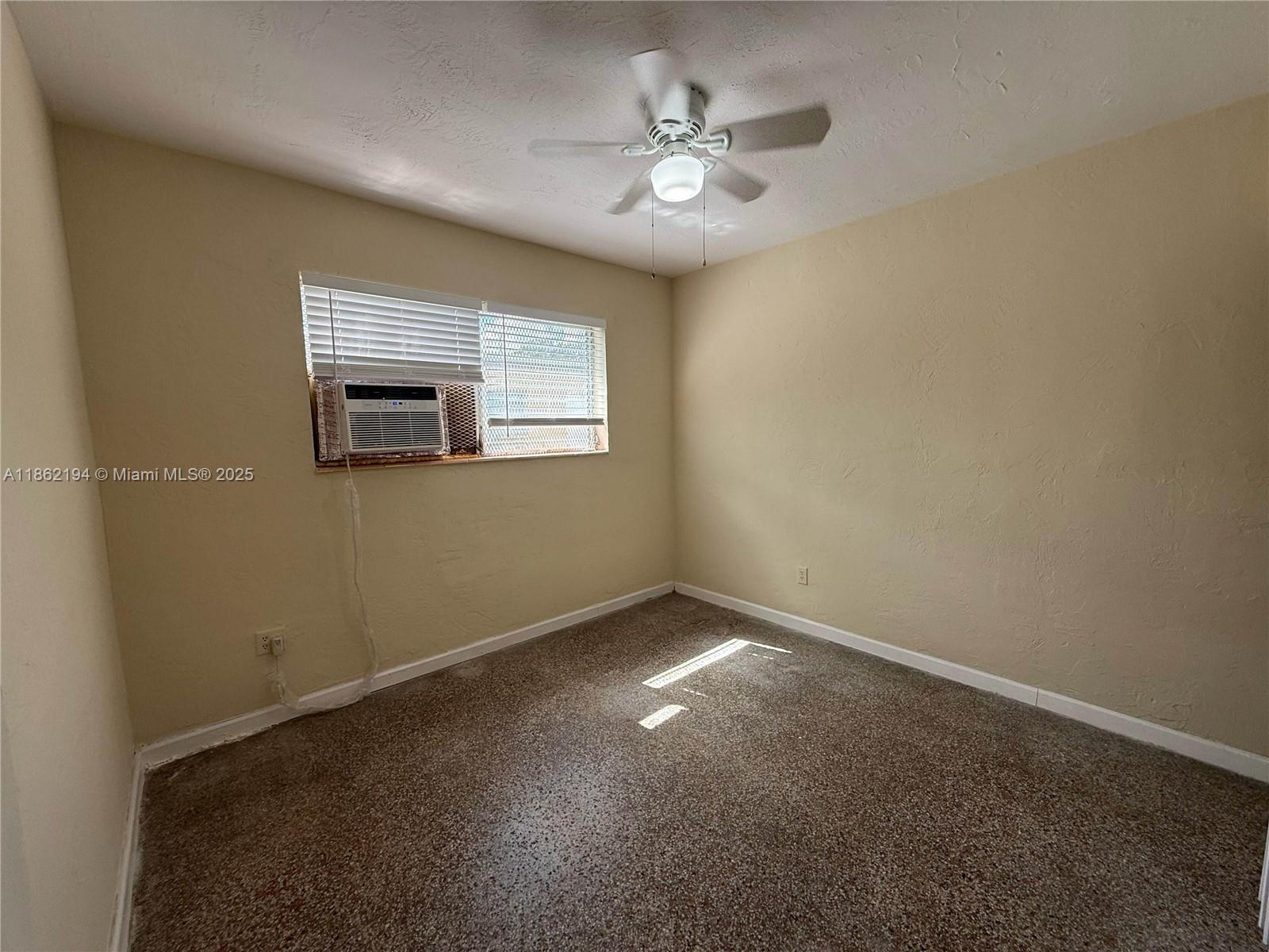 361 Sharar Avenue, Unit 1 Opa-Locka, FL 33054 - Photo 8 of 11 a view of an empty room with a window