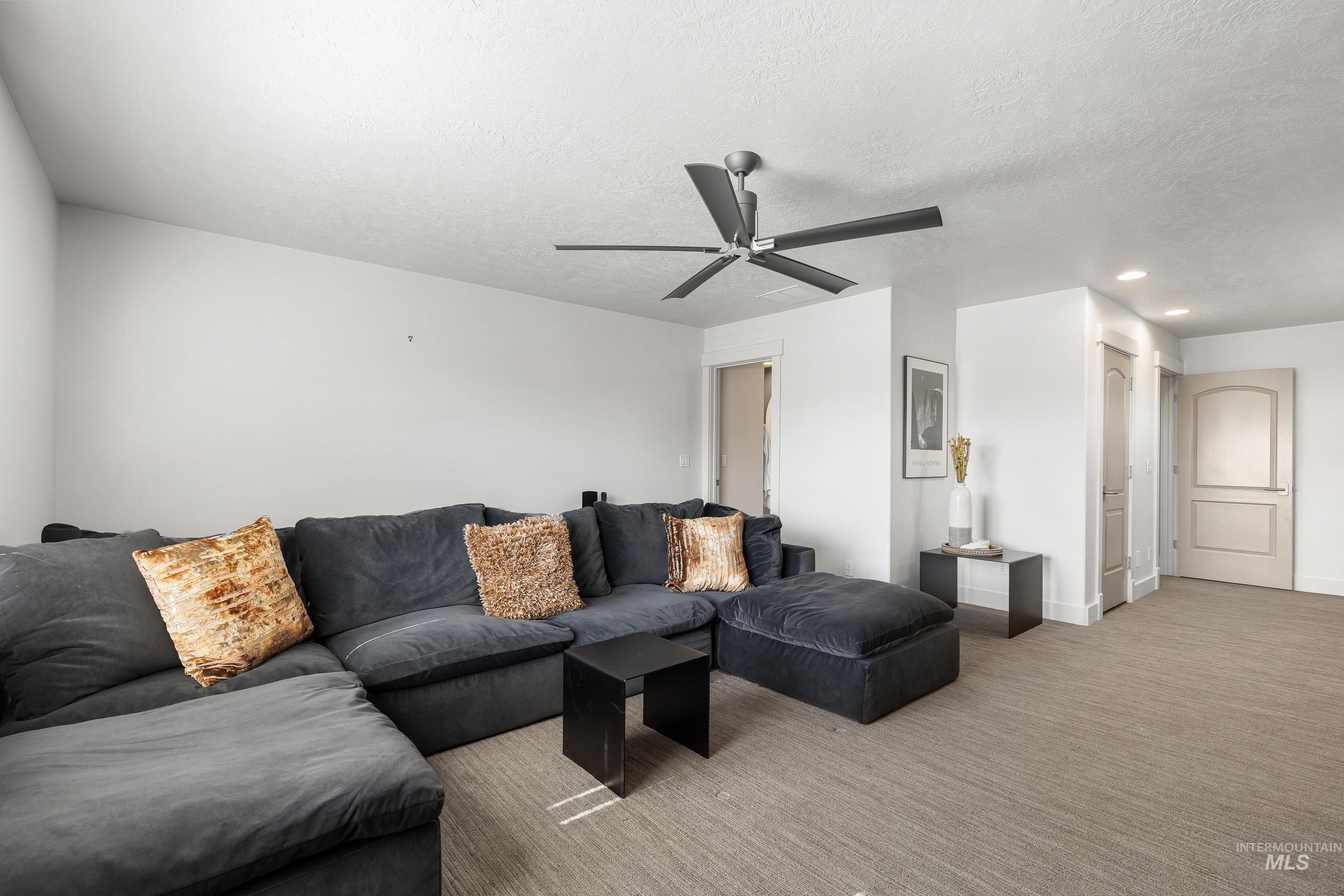 1166 East Rivers End Drive Eagle, ID 83616 - Photo 37 of 50 Living room featuring recessed lighting, carpet, a ceiling fan, and a textured ceiling