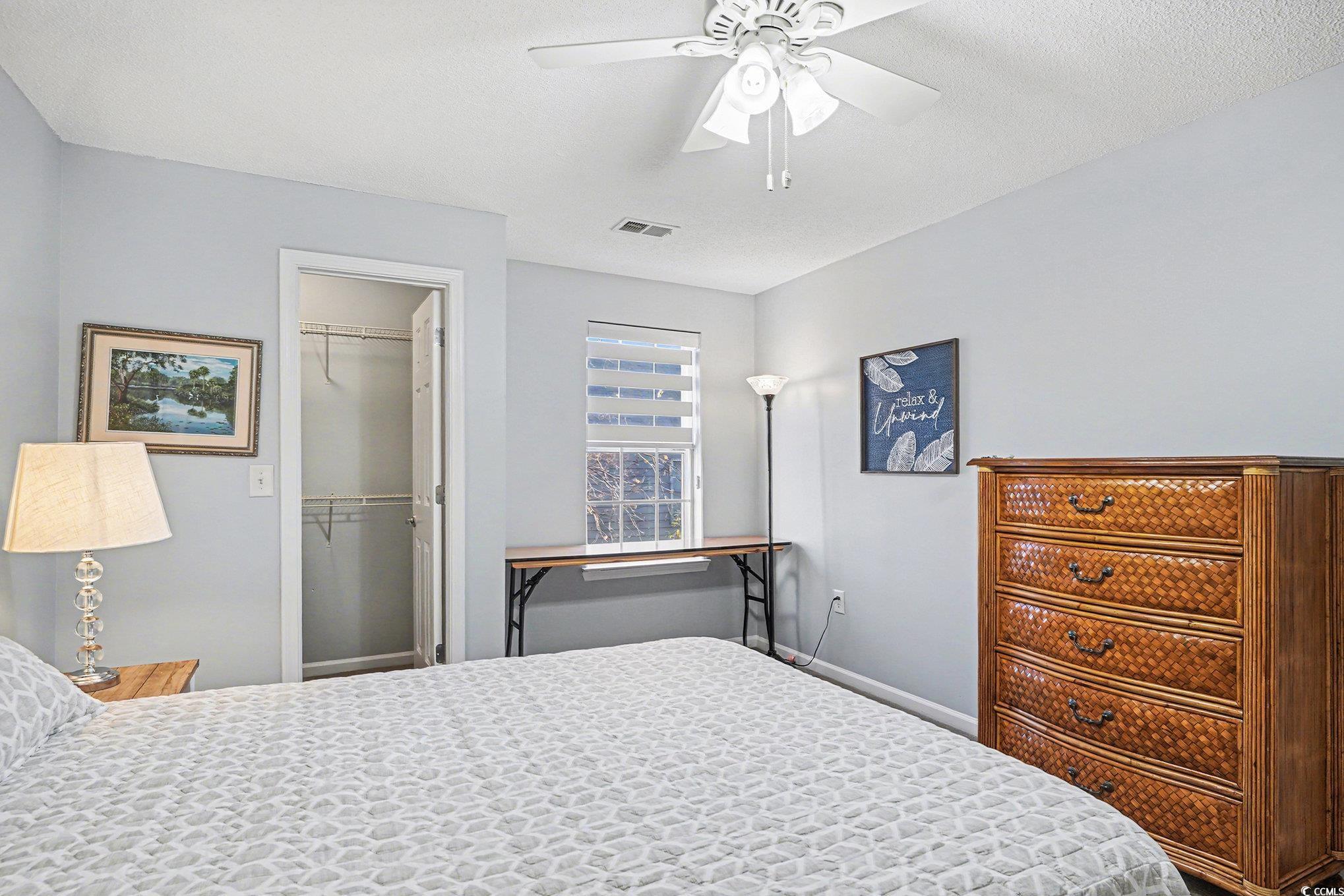 3756 Citation Way, Unit 926 Myrtle Beach, SC 29577 - Photo 18 of 35 Bedroom with a spacious closet, ceiling fan, and a textured ceiling