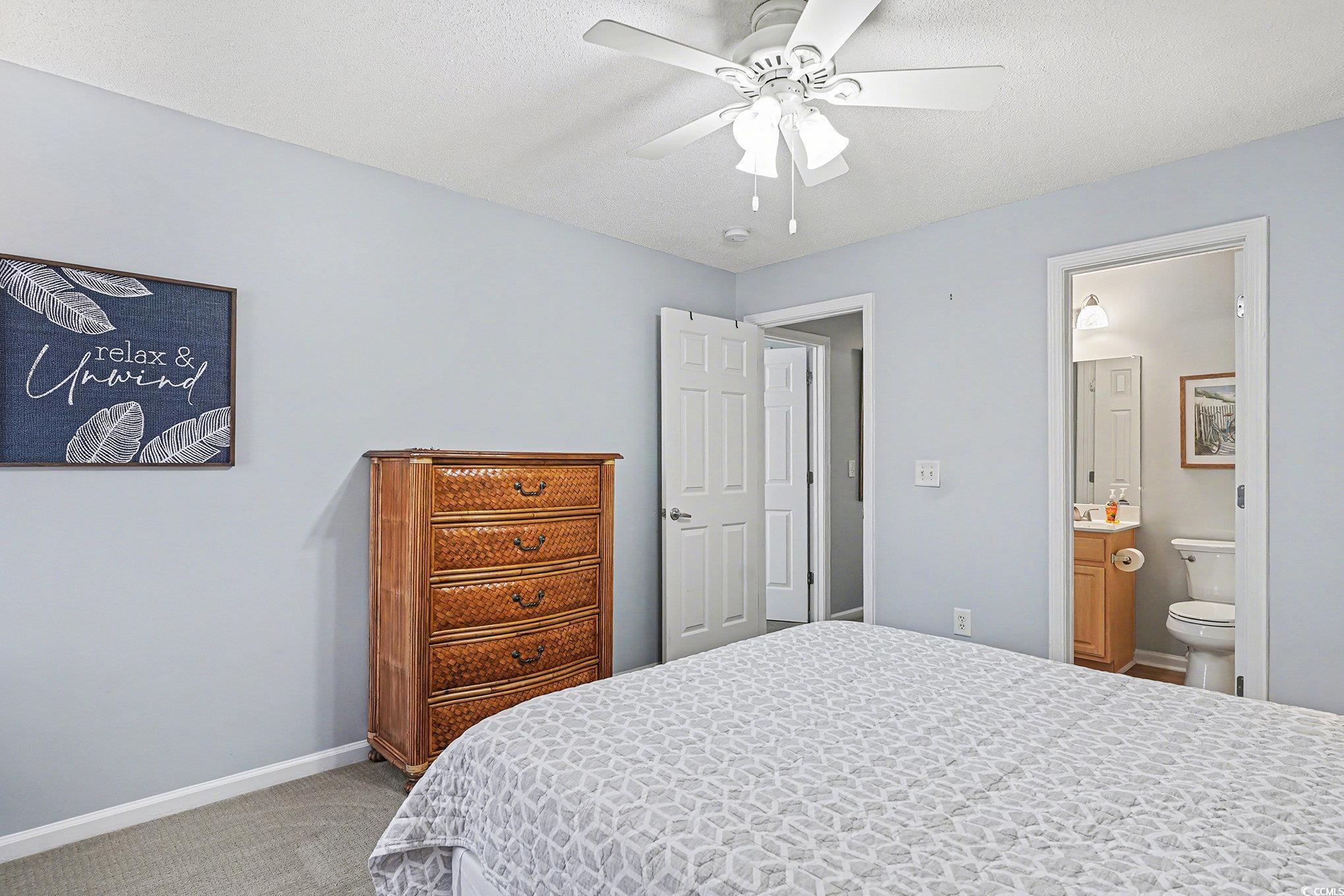 3756 Citation Way, Unit 926 Myrtle Beach, SC 29577 - Photo 19 of 35 Carpeted bedroom featuring a ceiling fan, a textured ceiling, and connected bathroom