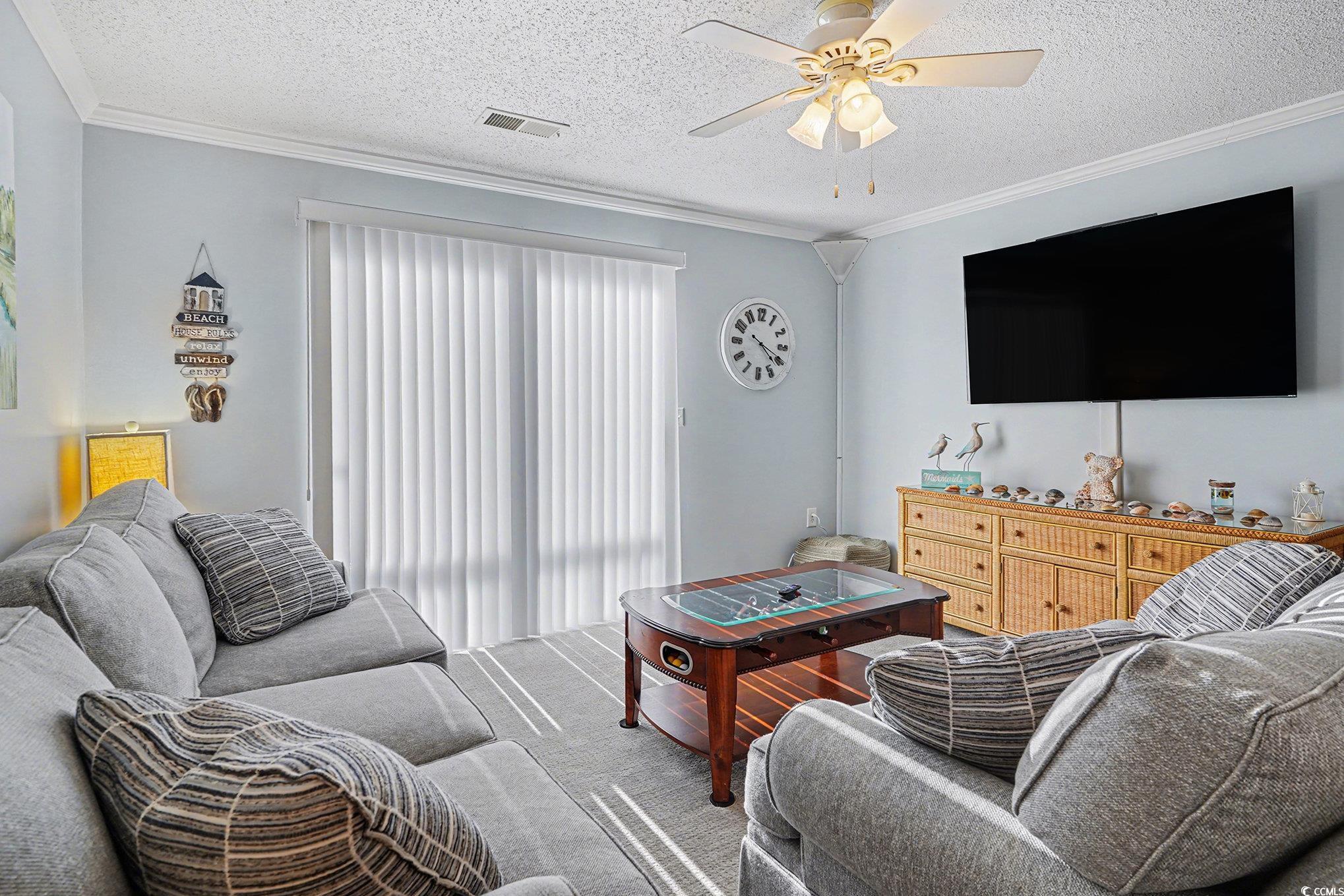 3756 Citation Way, Unit 926 Myrtle Beach, SC 29577 - Photo 6 of 35 Living room featuring a textured ceiling, crown molding, and a ceiling fan