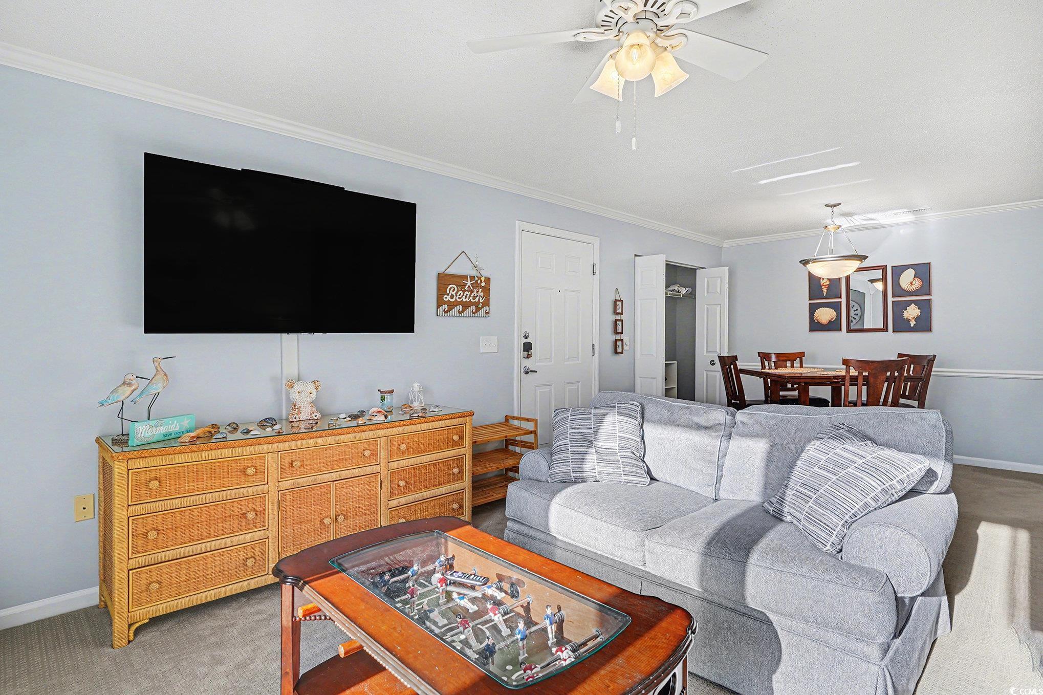 3756 Citation Way, Unit 926 Myrtle Beach, SC 29577 - Photo 7 of 35 Living area featuring carpet floors, crown molding, and ceiling fan