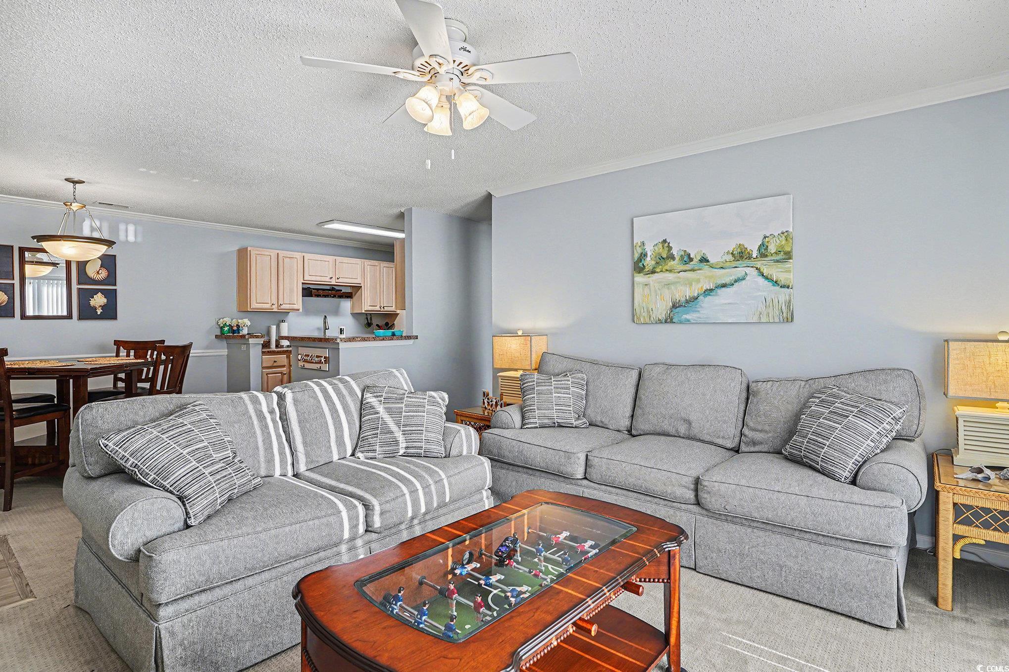 3756 Citation Way, Unit 926 Myrtle Beach, SC 29577 - Photo 8 of 35 Living area featuring carpet floors, a textured ceiling, ornamental molding, and ceiling fan