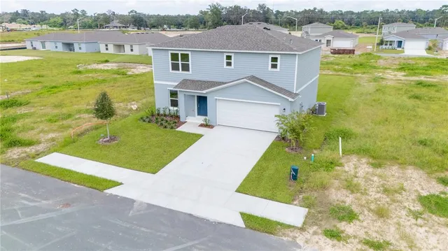 an aerial view of residential houses with outdoor space and swimming pool