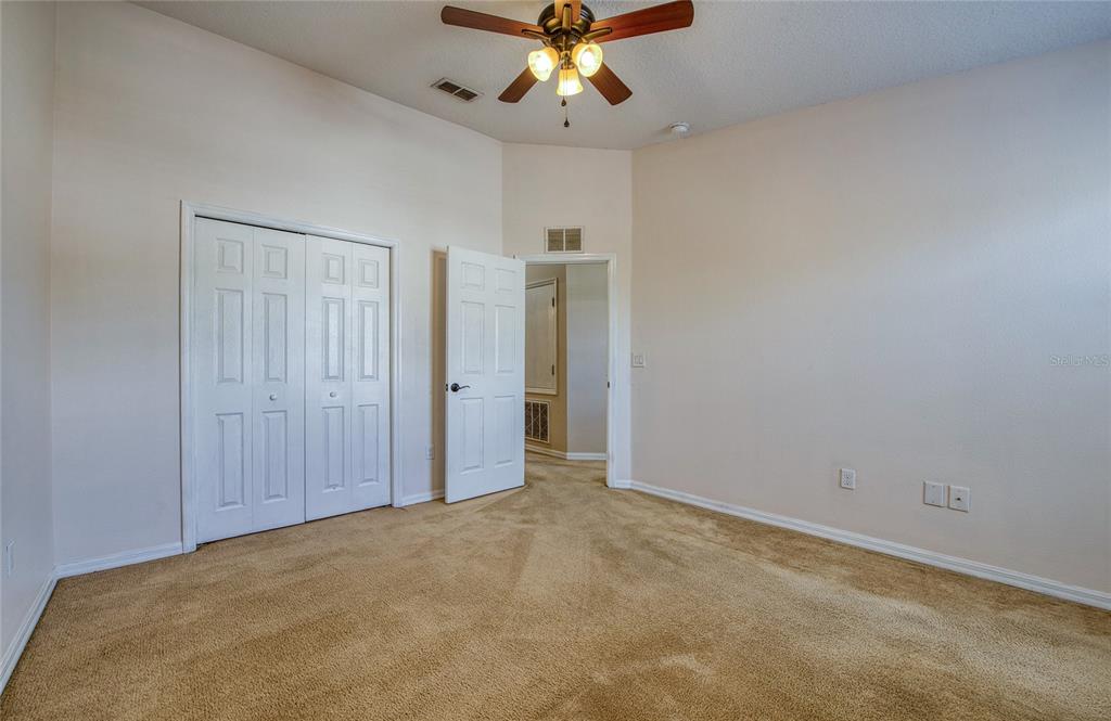 648 Spring Lake Circle Tarpon Springs, FL 34688 - Photo 14 of 30 an empty room with closet and a ceiling fan