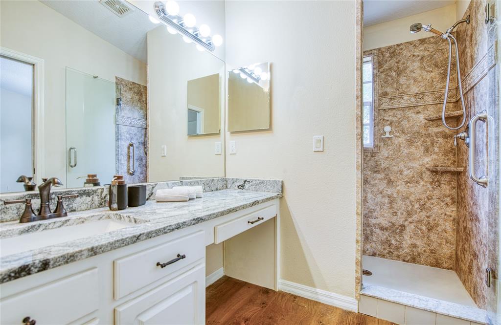 648 Spring Lake Circle Tarpon Springs, FL 34688 - Photo 19 of 30 a bathroom with a granite countertop sink and a mirror