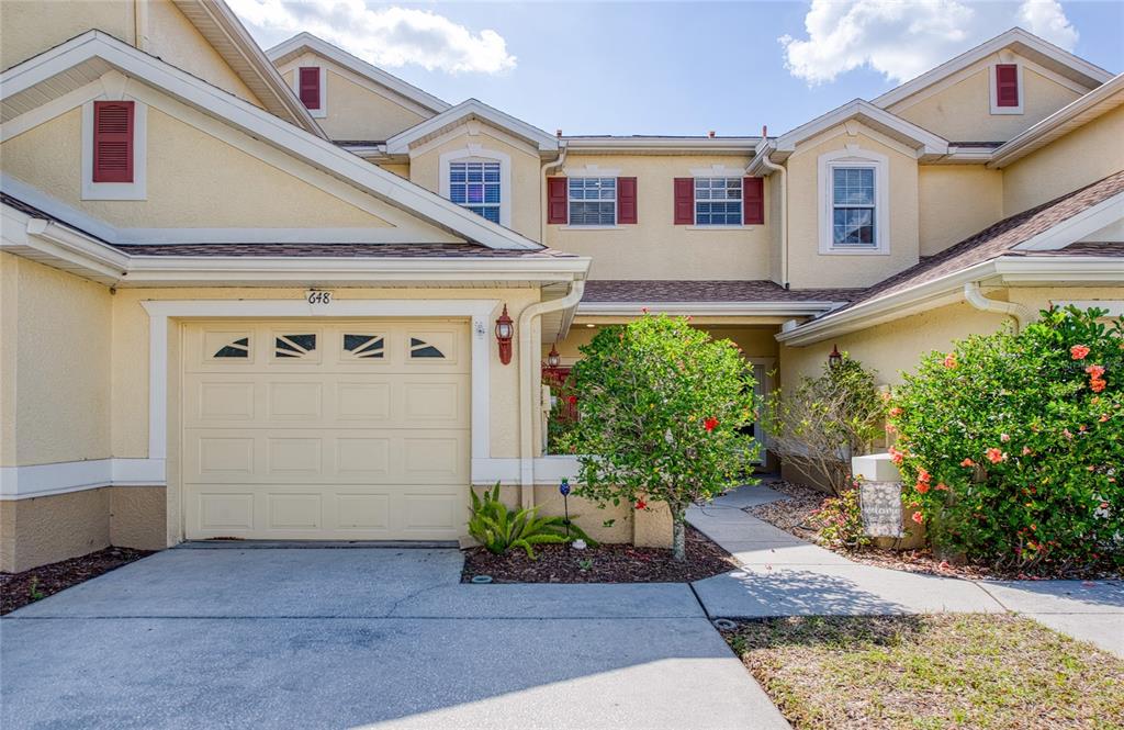 648 Spring Lake Circle Tarpon Springs, FL 34688 - Photo 2 of 30 a front view of a house with garden