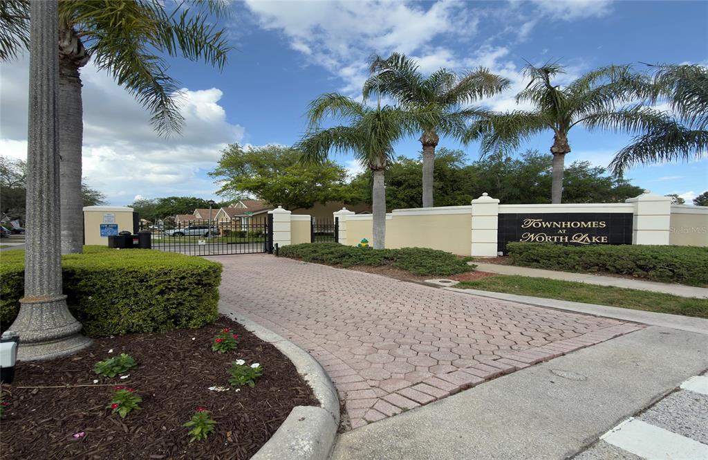 648 Spring Lake Circle Tarpon Springs, FL 34688 - Photo 30 of 30 front view of a house with a yard and potted plants