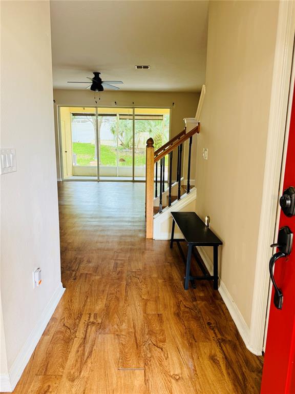 648 Spring Lake Circle Tarpon Springs, FL 34688 - Photo 3 of 30 a view of a hallway with wooden floor and furniture