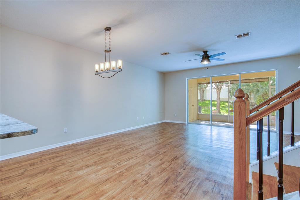 648 Spring Lake Circle Tarpon Springs, FL 34688 - Photo 4 of 30 a view of a room with wooden floor fan and windows