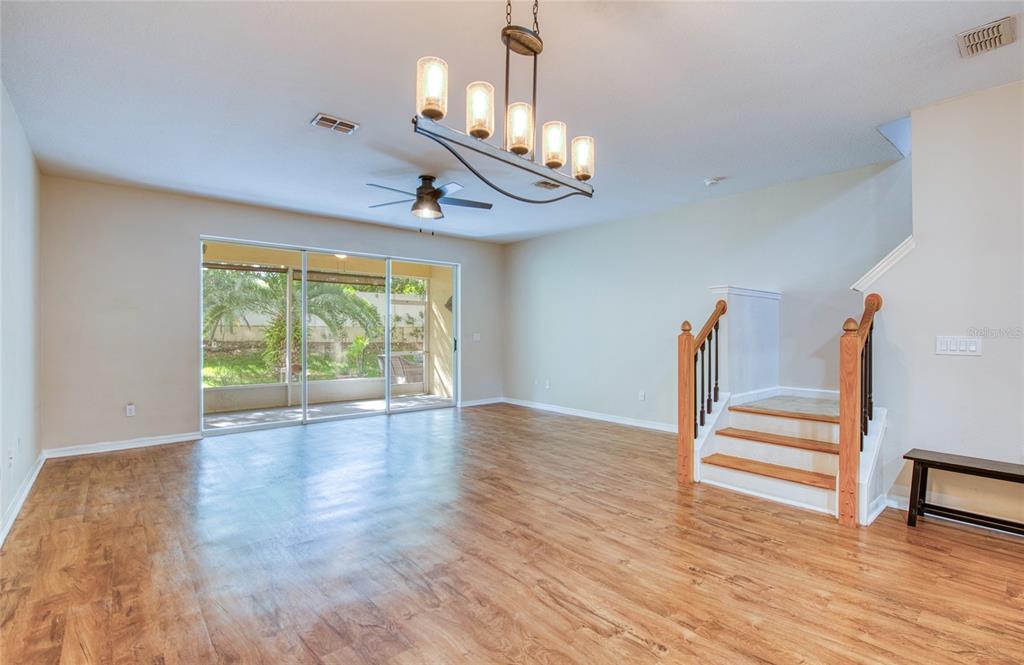 648 Spring Lake Circle Tarpon Springs, FL 34688 - Photo 5 of 30 a view of an empty room with wooden floor and a window