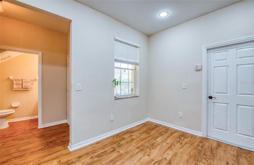 648 Spring Lake Circle Tarpon Springs, FL 34688 - Photo 10 of 30 a view of empty room with wooden floor and fan