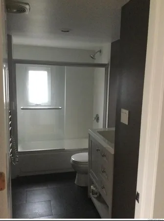 a bathroom with a toilet a sink and mirror