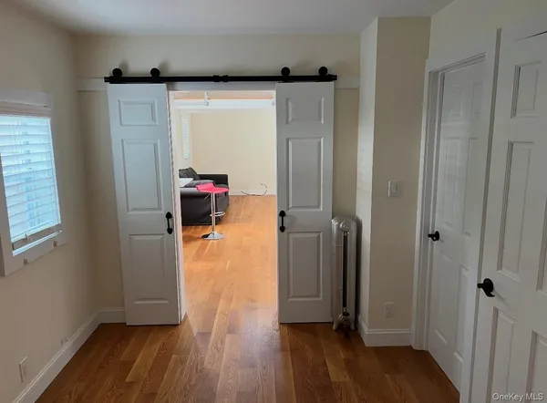 a view of walk in closet with wooden floor
