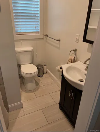 a bathroom with a sink toilet and mirror