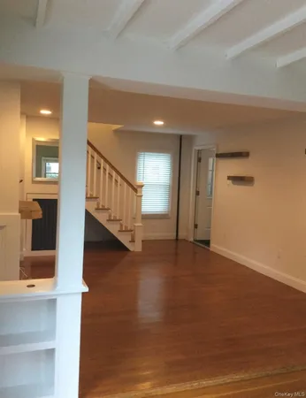 a view of an entryway with wooden floor