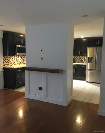 a kitchen with refrigerator and stove