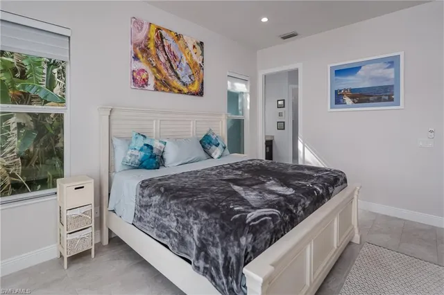 a bed sitting in a bedroom next to a window