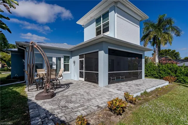 a view of a house with a yard and porch