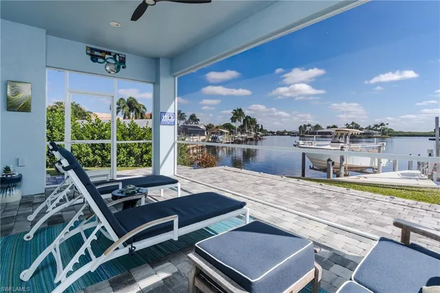 a living room with furniture pool table and a large window