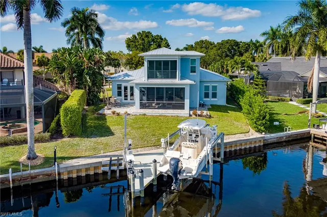 a view of a house with pool and chairs