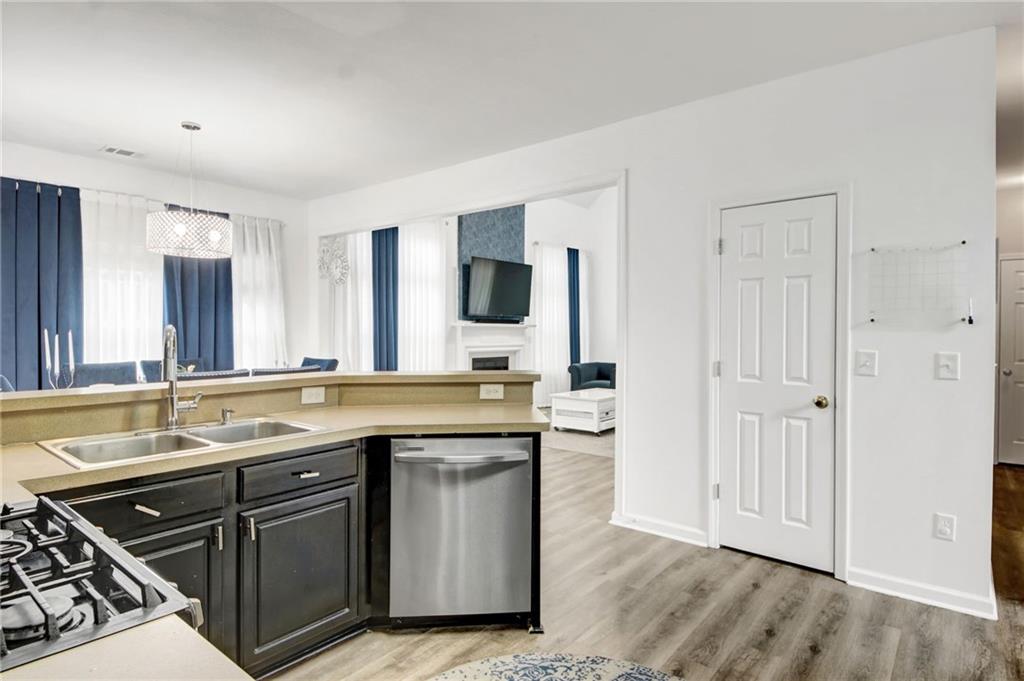 105 Fate Court Dallas, GA 30157 - Photo 11 of 32 a kitchen with a sink and a stove top oven with wooden floor