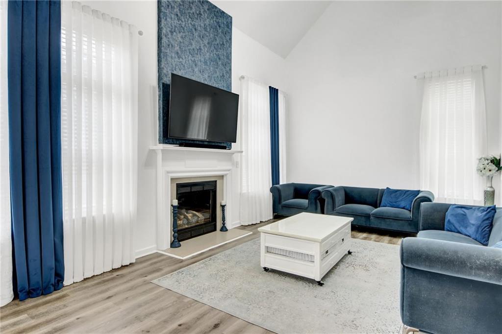 105 Fate Court Dallas, GA 30157 - Photo 16 of 32 a living room with furniture a flat screen tv and a fireplace