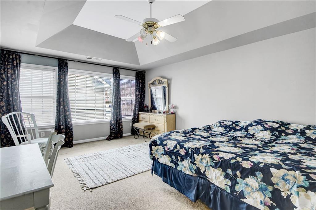 105 Fate Court Dallas, GA 30157 - Photo 19 of 32 a bed sitting in a bedroom next to a window