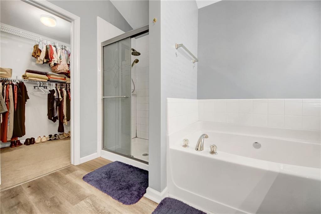 105 Fate Court Dallas, GA 30157 - Photo 22 of 32 a bathroom with a bathtub and a shower