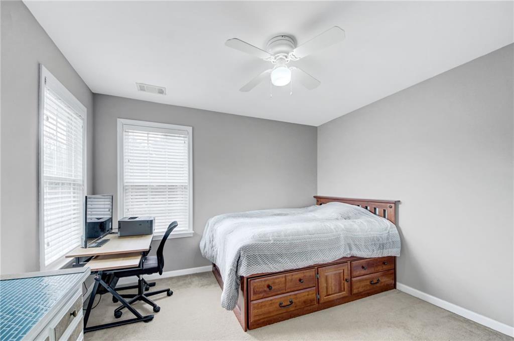 105 Fate Court Dallas, GA 30157 - Photo 23 of 32 a bedroom with a bed and a window