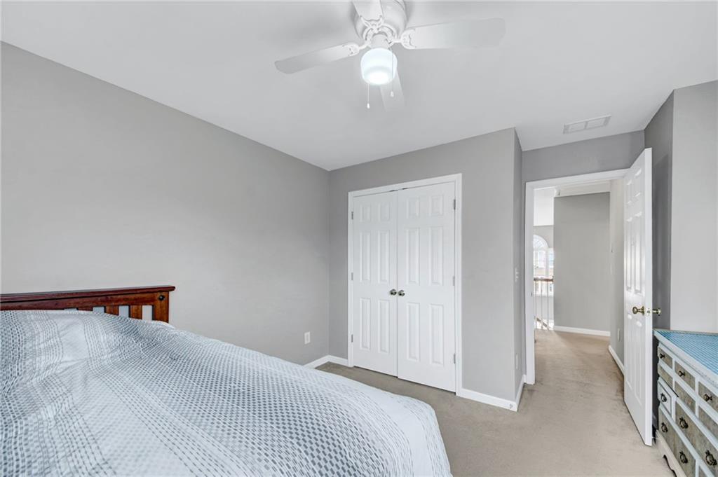 105 Fate Court Dallas, GA 30157 - Photo 24 of 32 a bedroom with a bed and a chandelier