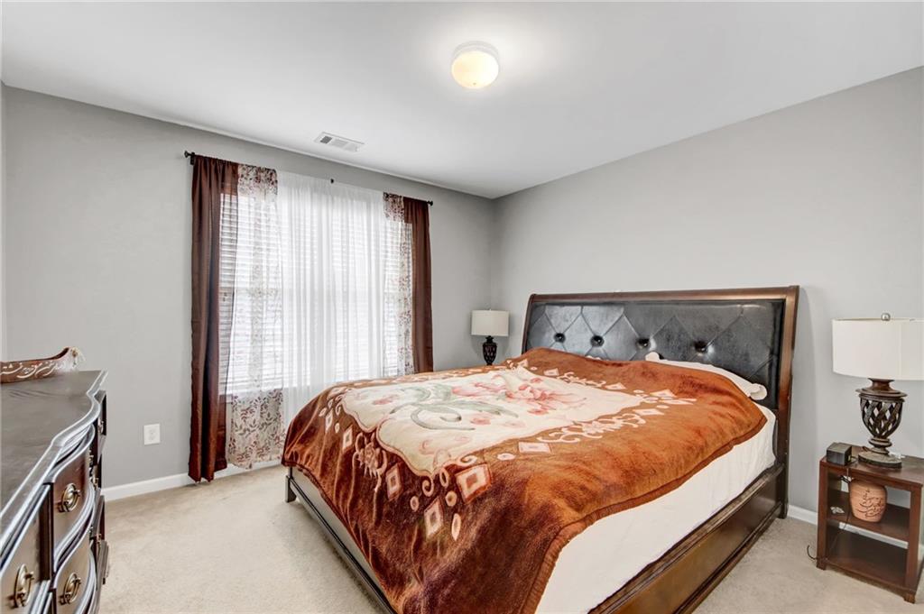 105 Fate Court Dallas, GA 30157 - Photo 28 of 32 a large bed sitting in a bedroom next to a window