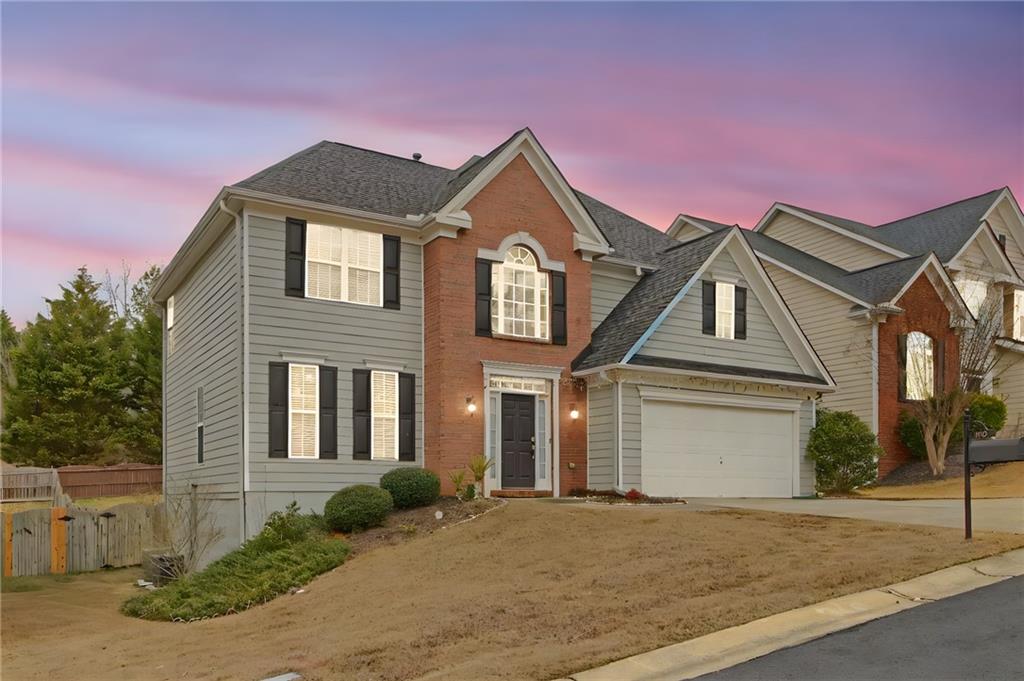 105 Fate Court Dallas, GA 30157 - Photo 4 of 32 a front view of a house with a yard and garage