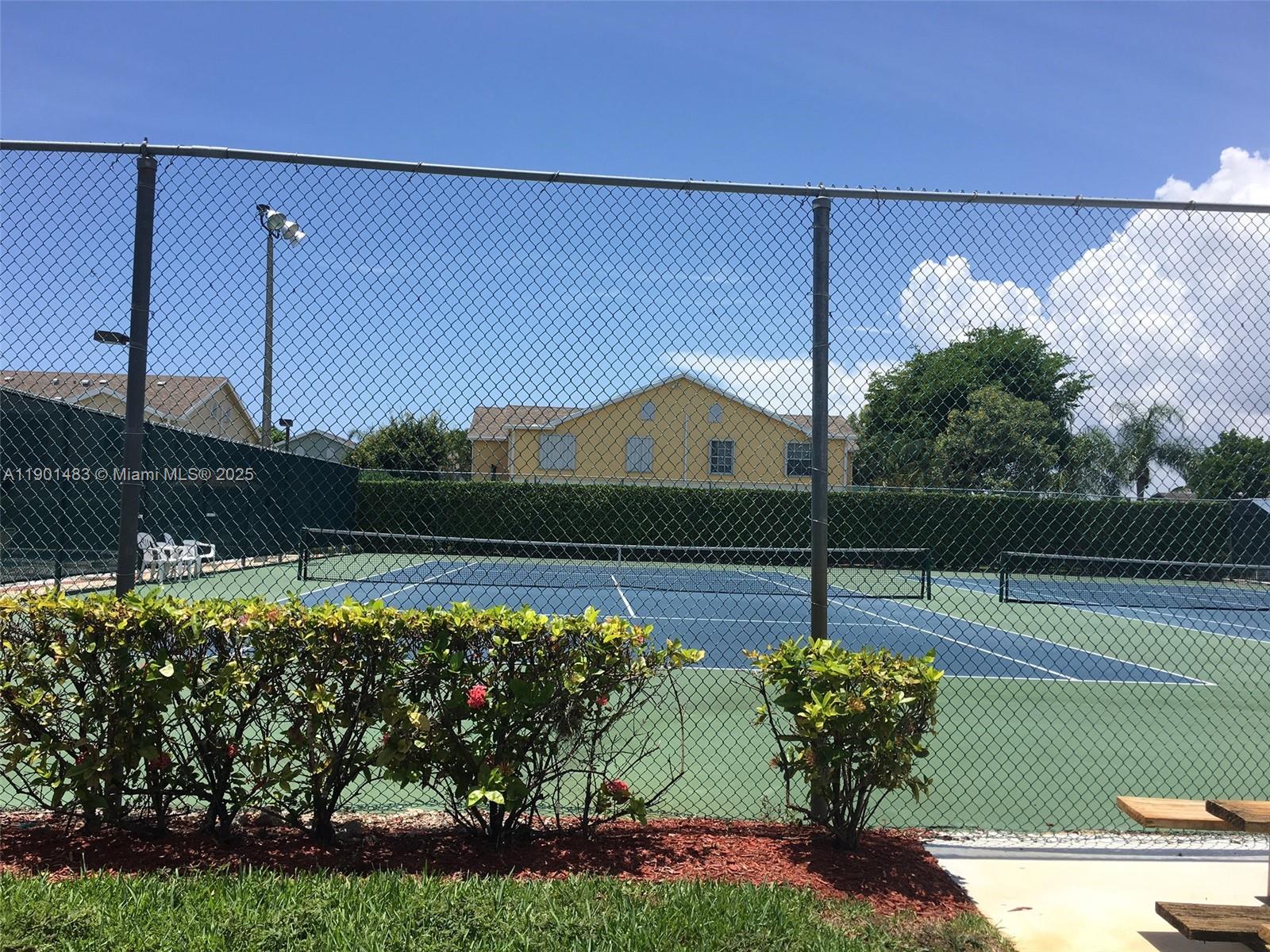 653 Waterside Drive, Unit 653 Hypoluxo, FL 33462 - Photo 11 of 12 a view of a tennis court