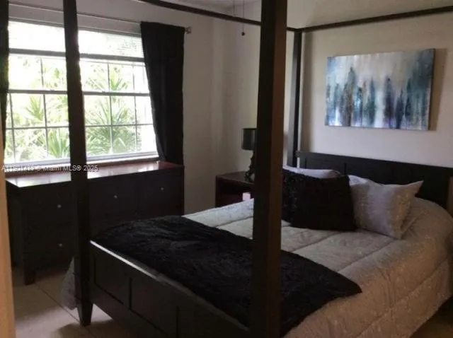 a living room with a black white bedspread and black walls