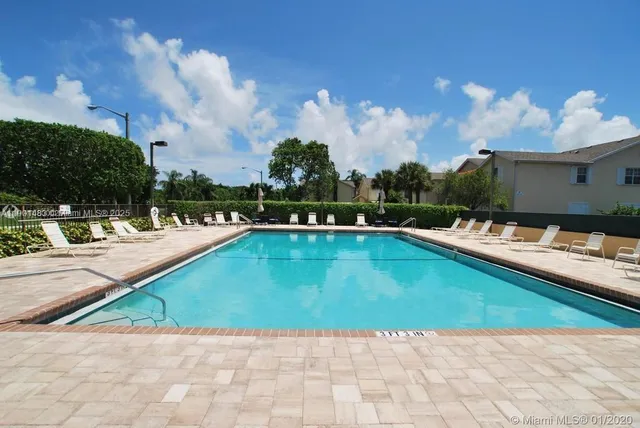 a view of a swimming pool with a lounge chairs