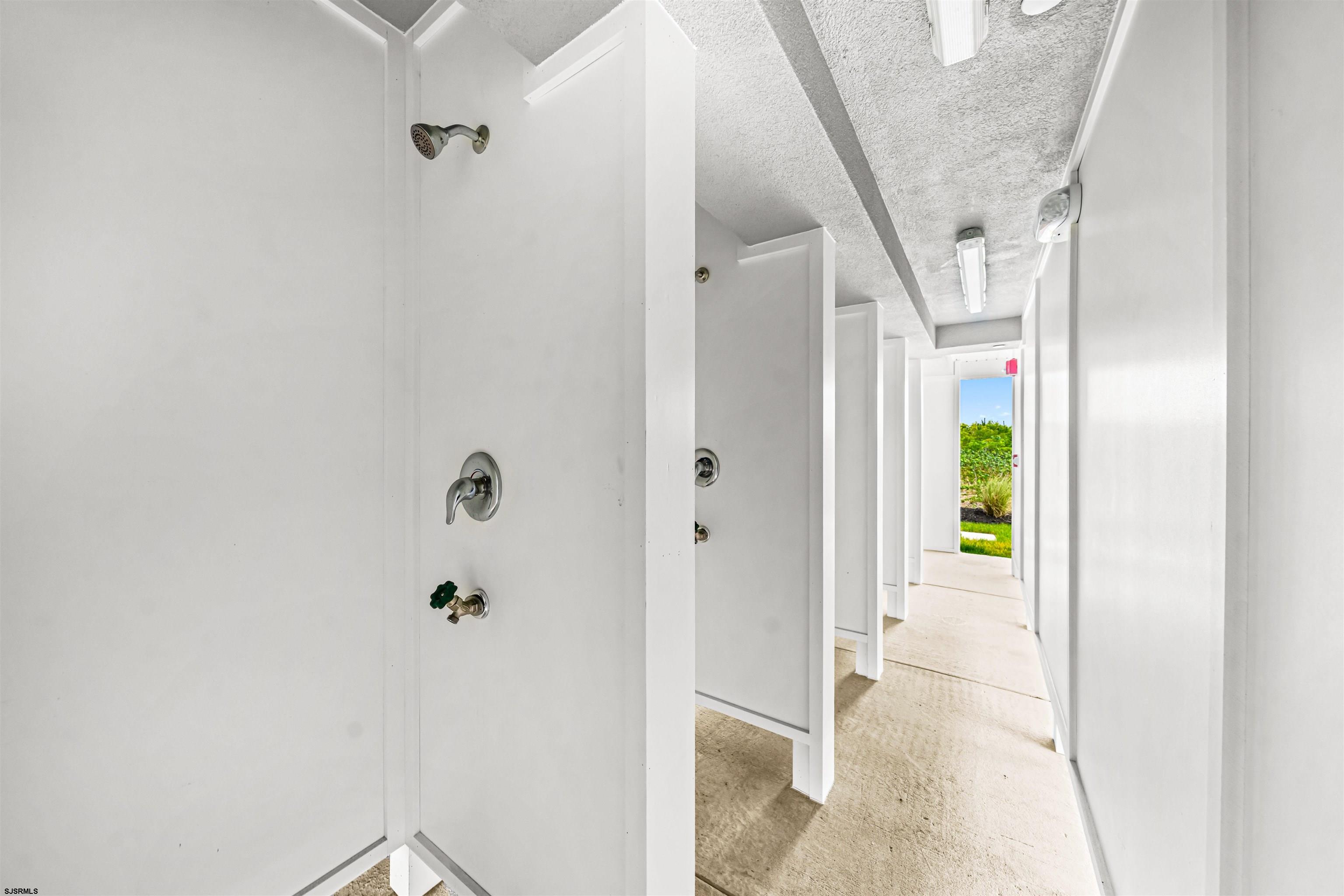 321 6th Street South, Unit 14 Brigantine, NJ 08203 - Photo 7 of 21 a view of a hallway with wooden floor and stairs