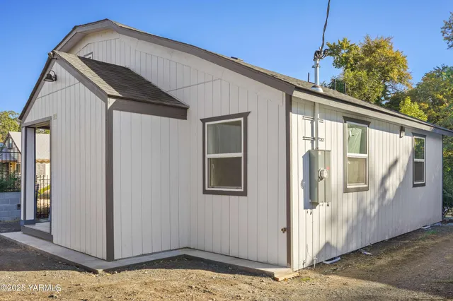 a front view of a house with wooden fence