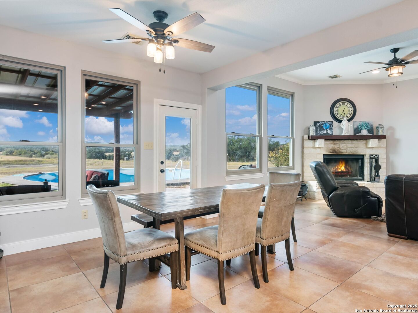 272 Schaper Road Fredericksburg, TX 78624 - Photo 16 of 62 a dining room with furniture a fireplace and chandelier