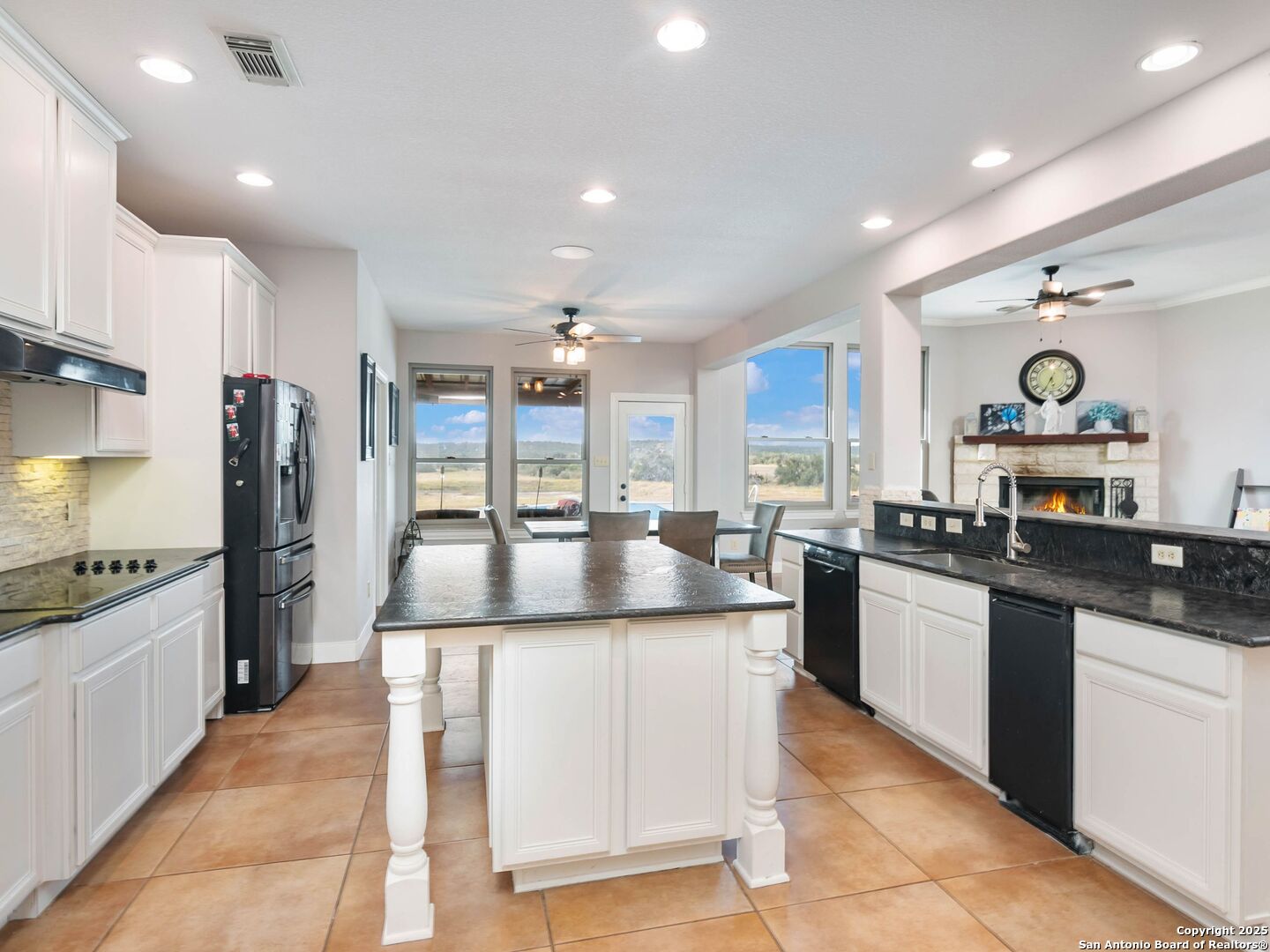 272 Schaper Road Fredericksburg, TX 78624 - Photo 19 of 62 a kitchen with stainless steel appliances granite countertop a sink and a refrigerator