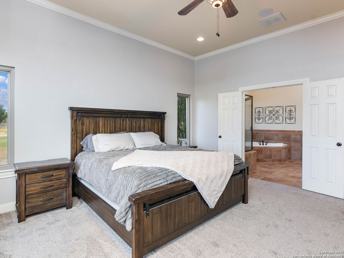 272 Schaper Road Fredericksburg, TX 78624 - Photo 23 of 62 a bed sitting in a bedroom and night stand