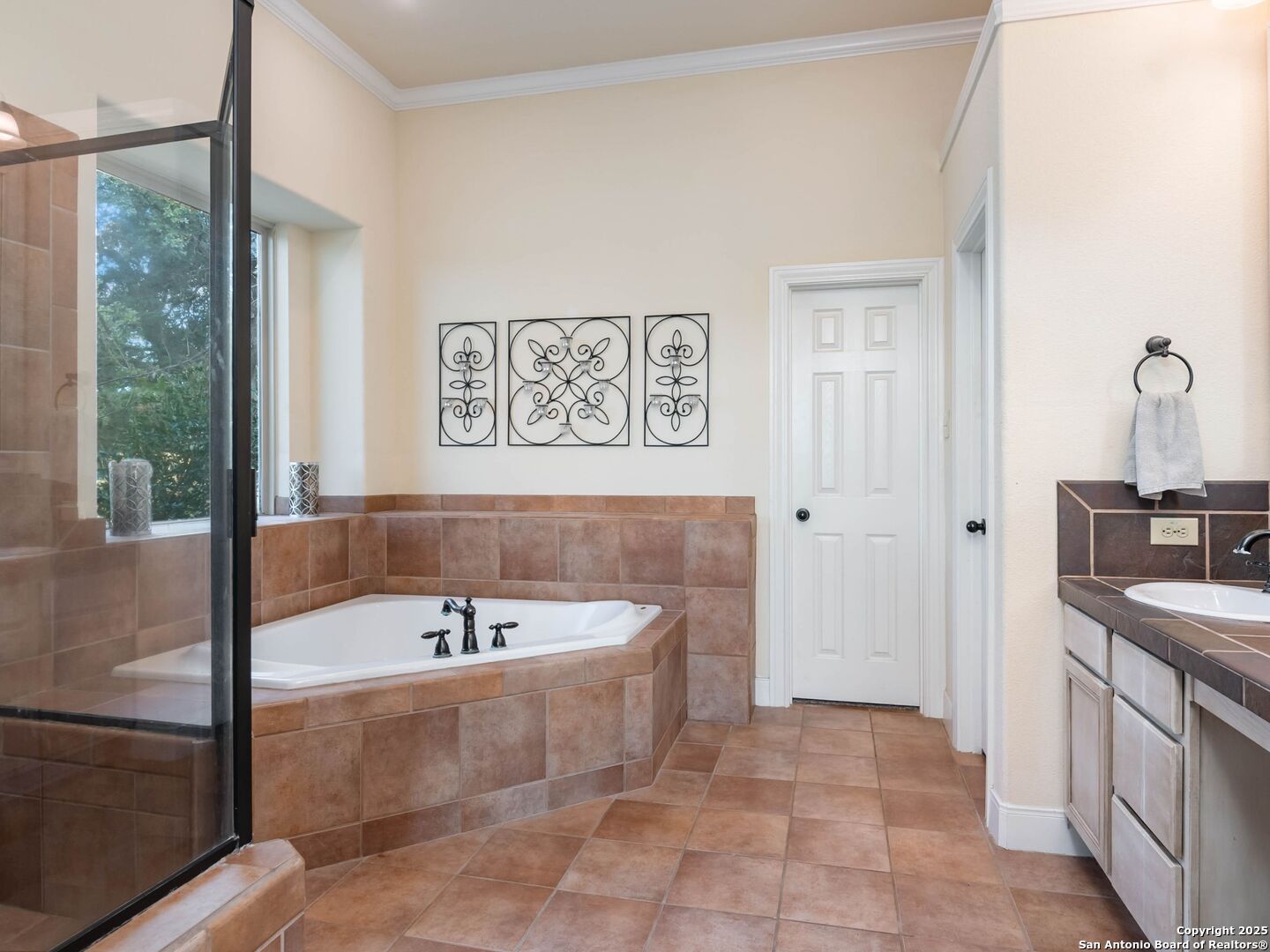 272 Schaper Road Fredericksburg, TX 78624 - Photo 24 of 62 a bathroom with a tub a sink and a window