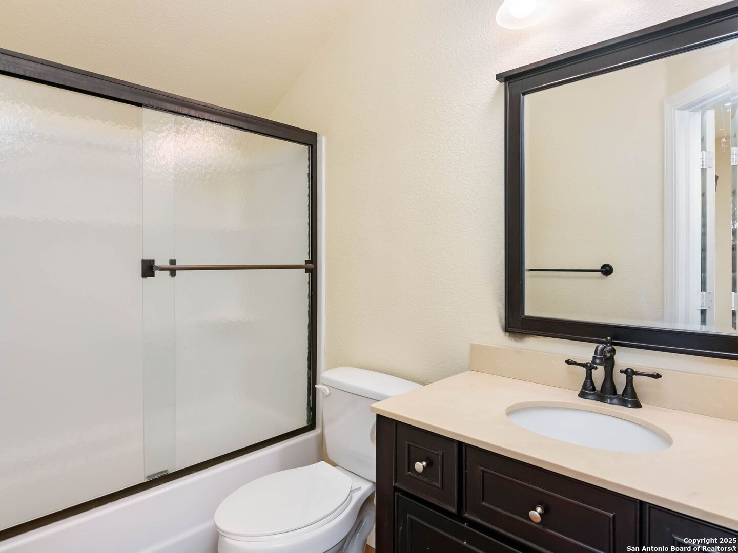 272 Schaper Road Fredericksburg, TX 78624 - Photo 34 of 62 a bathroom with a granite countertop sink toilet and a mirror