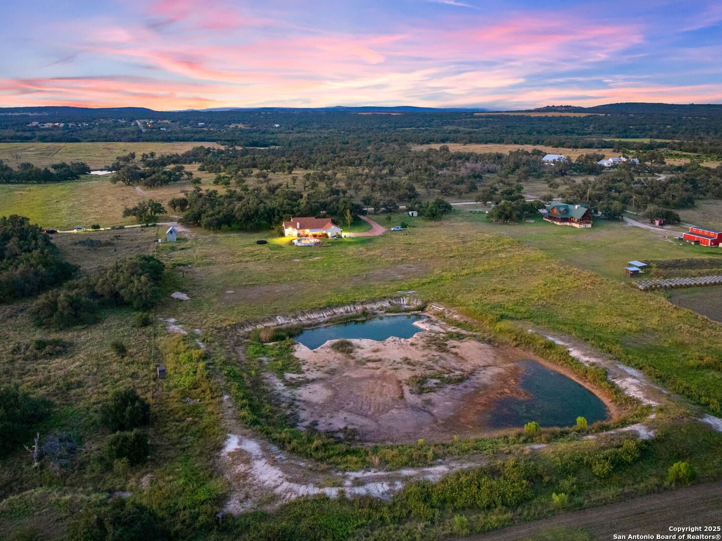 272 Schaper Road Fredericksburg, TX 78624 - Photo 49 of 62 a view of a lake with a building in the background