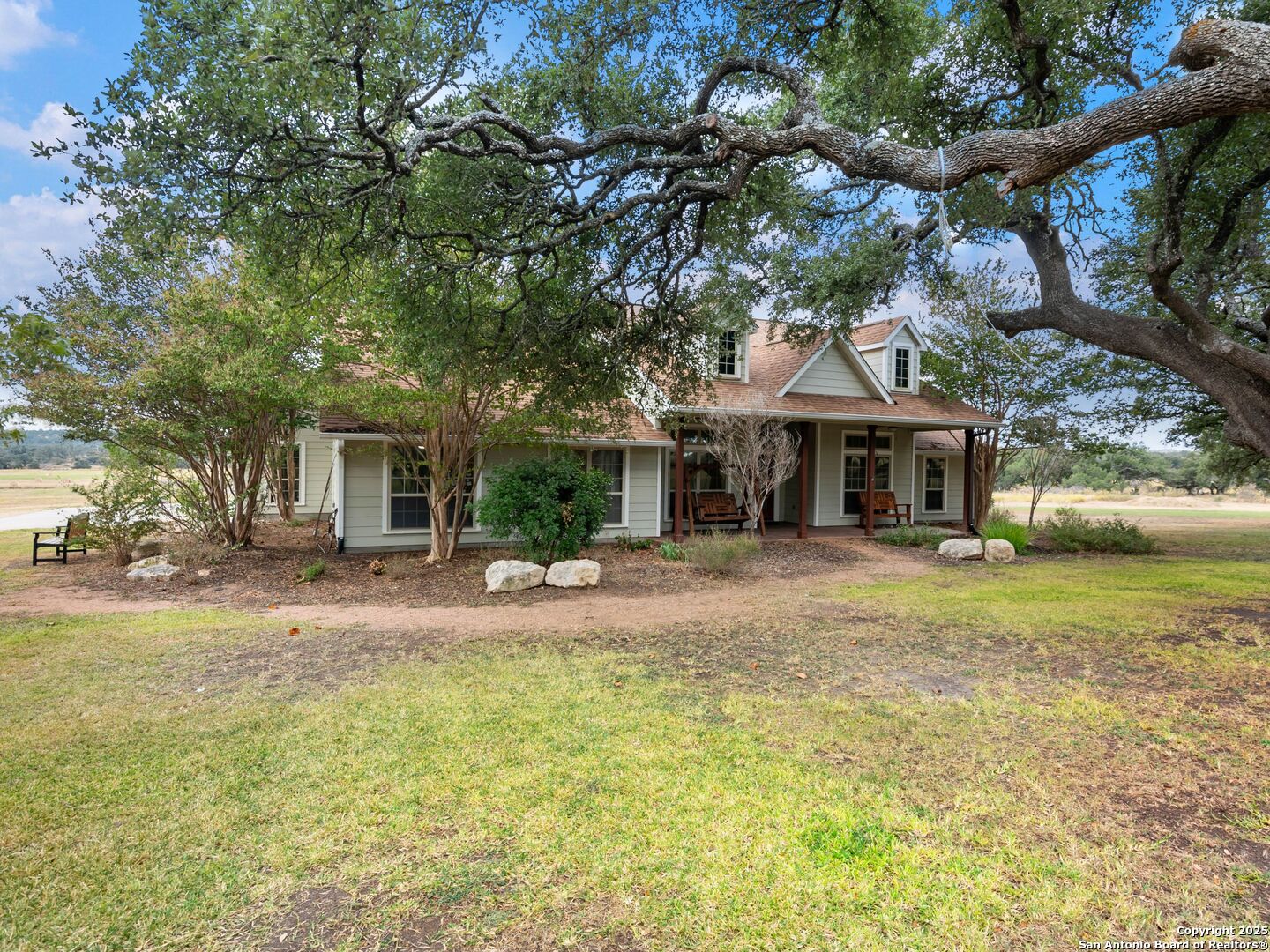 272 Schaper Road Fredericksburg, TX 78624 - Photo 6 of 62 a front view of a house with a garden and tree