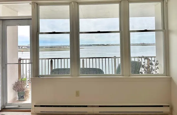 a view of a swimming pool with a lake from a balcony