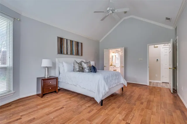 a spacious bedroom with a bed and a large window