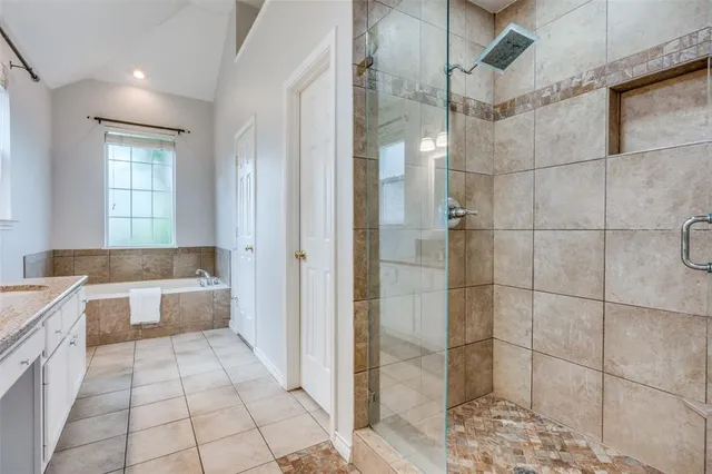 a spacious bathroom with a granite countertop sink a toilet a mirror and vanity